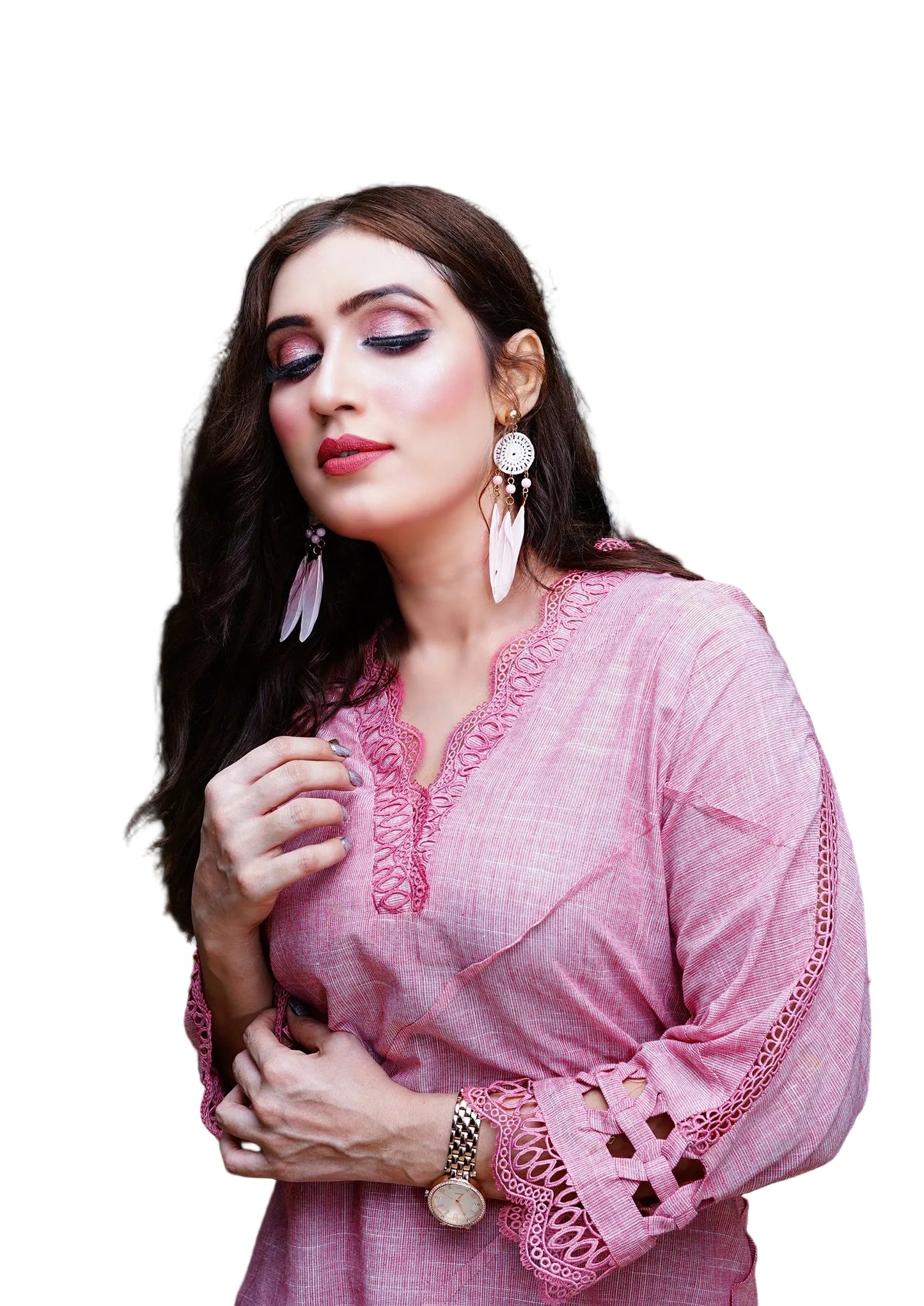 Woman wearing a pink traditional outfit with intricate designs on a white background