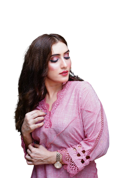 Woman wearing a pink traditional outfit with intricate designs on a white background
